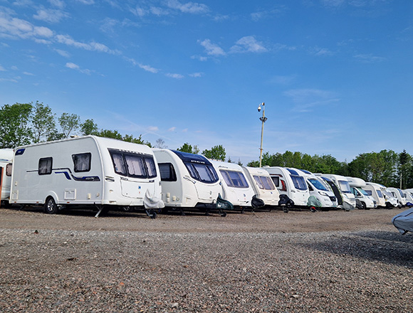 line of parked caravans under a blue sky showcasing various styles and designs ideal for 5 travel adventures